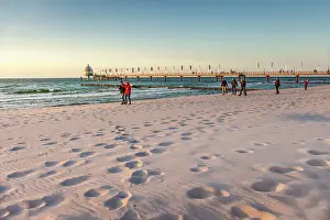 Walkers Prints: Walkers on the beach at the Zingst pier