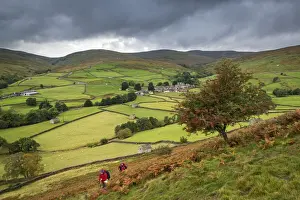 Walkers Prints: Two walkers walking on the Pennine Way through Swaledale in the Yorkshire Dales National Park
