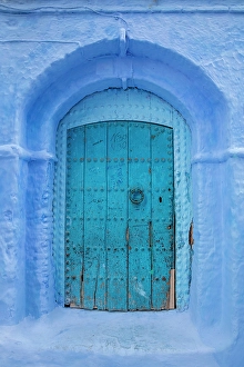 North African Prints: Wall and door painted blue, Chefchaouen, Rif Mountain, Morocco