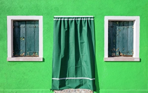 Burano Prints: Wall of a green house, with green window shutters, the island of Burano, Venice, Italy