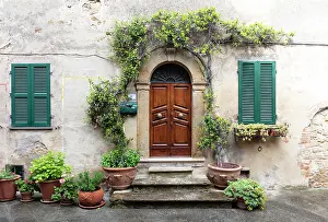 Montalcino Prints: Wall of old house with heavy wooden door