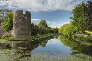 Images Dated 16th July 2021: The walls and moat of Wells Bishops Palace on summer evening, Wells, Somerset