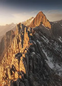 The warm light of the sunset hit the Mt. Macina and the Apuan Alps during winter, Tuscany
