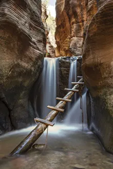 Gulch Prints: Waterfall and ladder in Kanarra Creek Canyon. Kanarraville, Iron County, Utah, USA