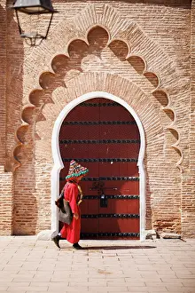 Marrakech Prints: Waterseller in front of iconic door, Marrakech, Morocco