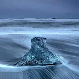 Icelandic Prints: Wave washing around an Iceberg stranded on the beach