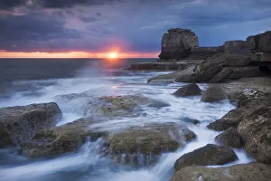 Waves break over the rocky shoreline of Portland Bill, Isle of Portland, Dorset, England Waves break over the rocky shoreline of Portland Bill, Isle of Portland, Dorset, England