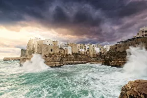 Puglia Gallery: Waves crash on the cliff during a winter storm at sunrise