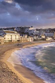 Waves crash against Porthmeor Beach in St Ives, Cornwall, England