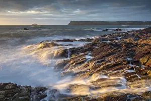 North Coast Prints: Waves crash over sun drenched rocks near Polzeath on the North Coast of Cornwall