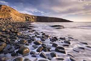 Waves lap against the seashore at Cullernose Point near Howick, Northumberland, England