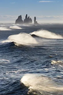 Formation Prints: Waves moving to Reynisfjara beach, with the Reynisdrangar sea stacks on the horizon