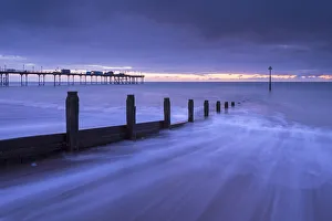 Waves rush over the beach at Teignmouth at dawn, Devon, England. Winter (January) 2016