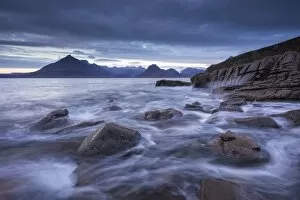 Waves rush around the rocky shores of Elgol, Isle of Skye, Scotland. Winter (December)