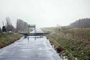 Welney, Cambridgeshire, UK. A frozen drainage ditch attracts skaters