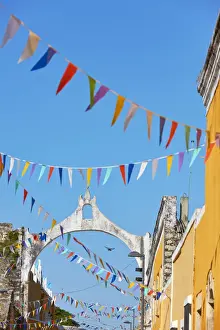 Yucatan Prints: The white arch in colonial architecture of Izamal with colorful flags