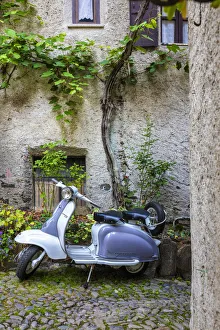 Motorcycle Prints: White and grey Lambretta Innocenti scooter in a courtyard, Morbegno, province of Sondrio