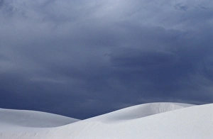 Graphic Prints: White sand dunes contrast against a stormy