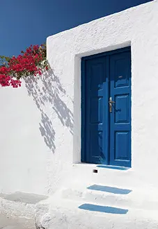 Blue Door Prints: White wall with blue door and bougainvillea