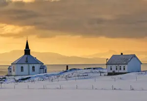 Nordland County Prints: The white wooden octagonal church of Dverberg in the cold morning snowy landscape