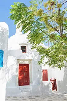Mykonos Prints: Whitewashed church with with red door