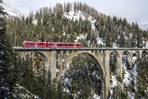 Viaducts Prints: Wiesener Viaduct surrounded by snowy mountains and woods. Engadine. Canton of Graubunden