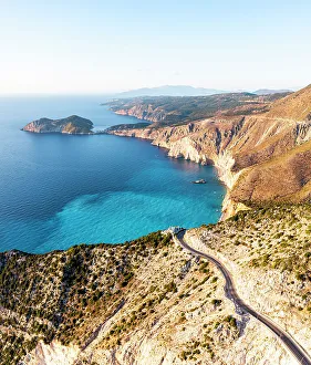Road Trip Prints: Winding coastal road overhanging the blue sea, Assos, Kefalonia, Ionian Islands, Greece