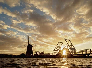 Stream Gallery: Windmill in Kinderdijk at sunset, UNESCO World Heritage Site, South Holland, The