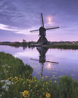 Windmill and moon reflected in the canal, Kinderdijk, Molenlanden, South Holland