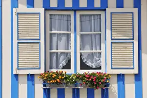 Window of a traditional striped painted house in the little seaside village of Costa Nova