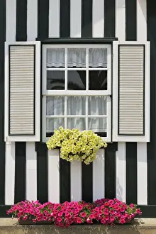 Window of a traditional striped painted house in the little seaside village of Costa Nova