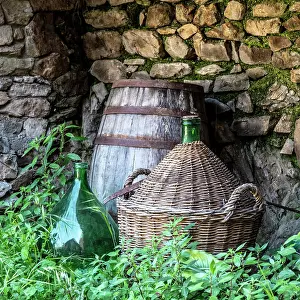 Manarola Prints: Wine bottles and barrel, the village of Manarola