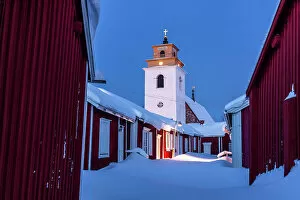Images Dated 31st October 2022: Winter dusk over the old bell tower and wood cottages covered with snow, Gammelstad Church Town