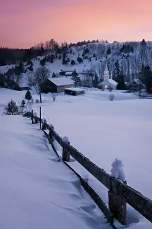 Q3 2025 Prints: Winter dusk over white-steeple church and barn with farmer fenc