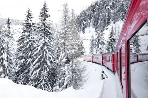 Red Train Prints: Winter landscape after a blizzard seen during a journey on board of Bernina Express train