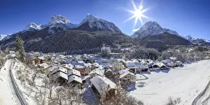 Fountain Prints: Winter at Scoul village at Engadine, in the background the Lichana peak, Switzerland
