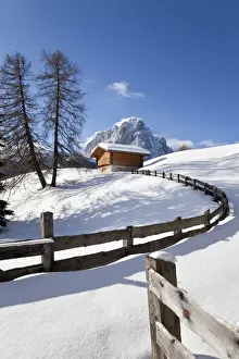 Val Gardena Prints: Winter snow covered mountain hut in front of Sassolungo mountain (3181m), Val Gardena