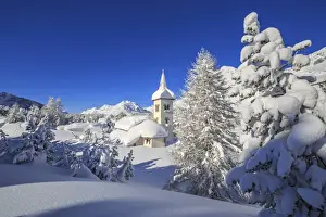 Bell Towers Prints: The winter sun illuminate the snowy landscape and the typical church Maloja Canton