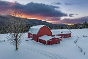 Snow Flurry Prints: Winter sunrise over red barn and dairy farm in Green Mountains
