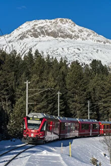 Winter view of the famous Bernina Express red train near Pontresina, Graubunden