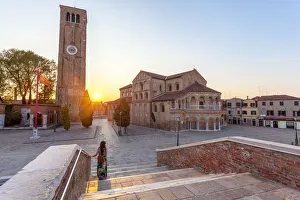 Admire Gallery: A woman admires the Church of Santa Maria e San Donato (Murano Cathedral) at sunset