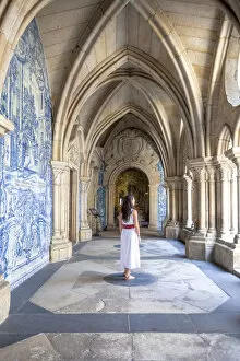 A woman admires the cloister arcades of Porto Cathedral (Sao do Porto), Porto