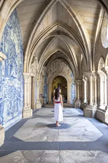 Historic Centre Prints: A woman admires the cloister arcades of Porto Cathedral (Sao do Porto), Porto