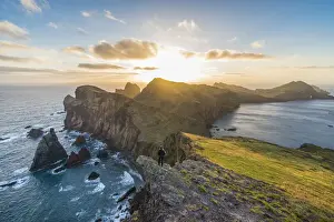 Woman admiring the view of point of St Lawrence and Furado Point at dawn. Canical