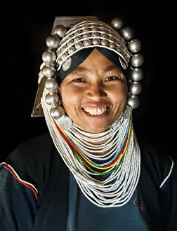 A woman from Akha tribal village wearing traditional headdress made of heavy silver