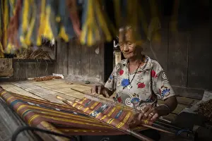 Fabrics Prints: A woman in Bena village making woven fabrics called Tenun Ikat. Flores Island