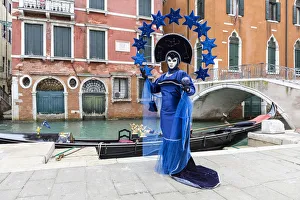 High Tide Prints: Woman in blue costume posing by canal during Carnival, Venice, Veneto, Italy