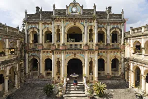 Images Dated 14th December 2017: A woman carrying an umbrella walks into the Hoang A Tuong ancient palace in Bac Ha