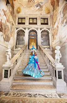 Costume Gallery: Woman in costume standing on staircase in Ca Segredo palace during Carnival, Venice