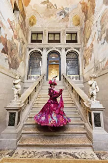Painting Gallery: Woman in costume standing on staircase in Ca Segredo palace during Carnival, Venice